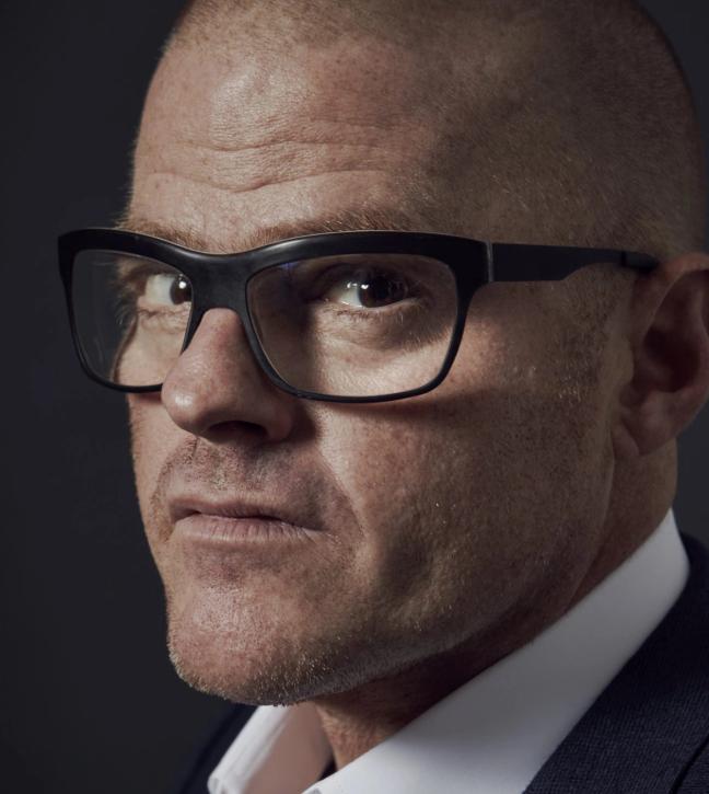 heston blumenthal wears glasses in a suit